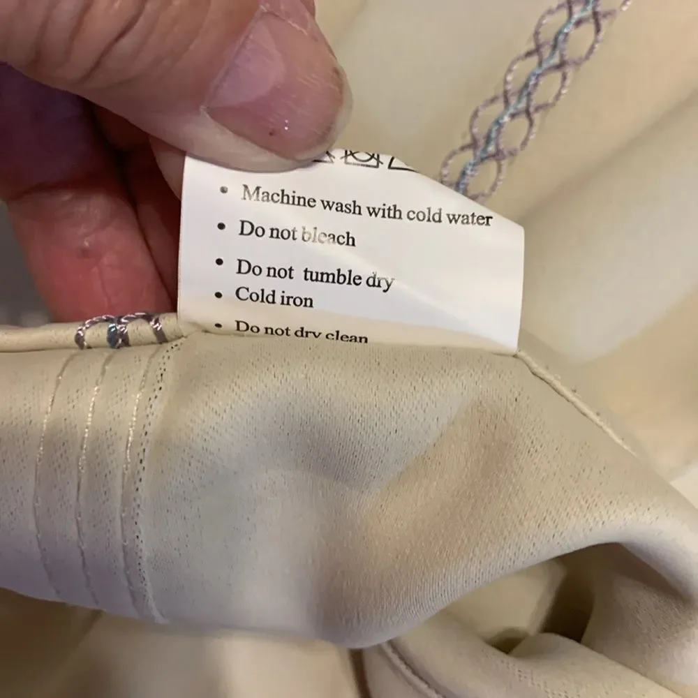 One pair (two panels) cream valance with blue/purple detail